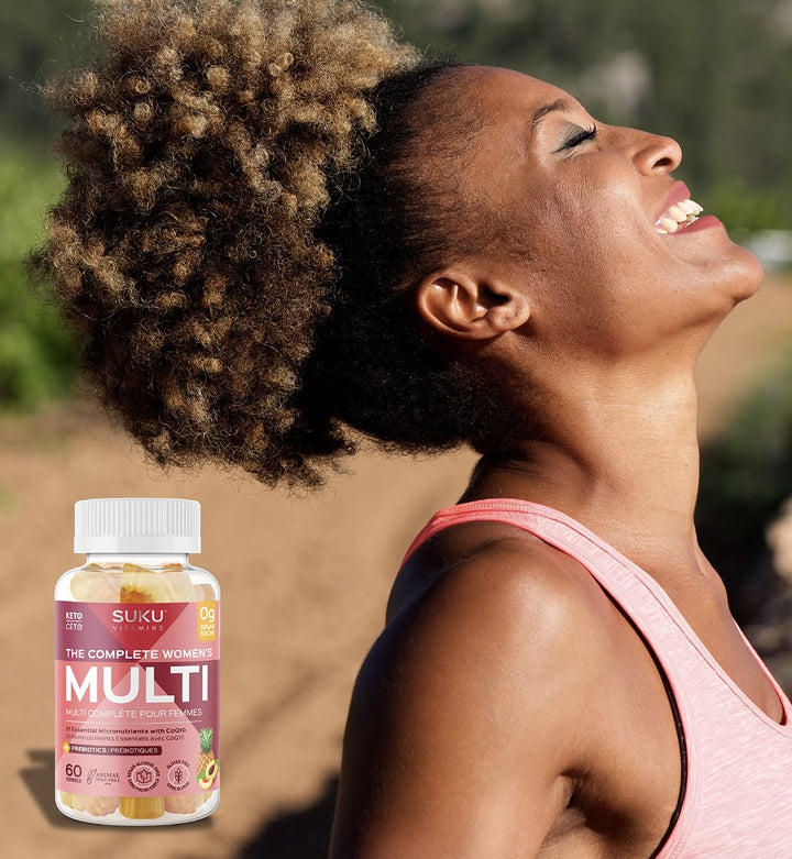 Woman outdoors with a bottle of Suku Complete Women's Multi vitamins in the foreground.